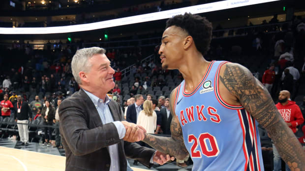 Atlanta Hawks owner owner Antony Ressler greets Atlanta Hawks forward John Collins (20) after a game against the Houston Rockets at State Farm Arena.